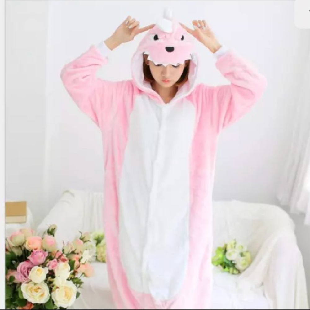 A plush pink dinosaur onesie